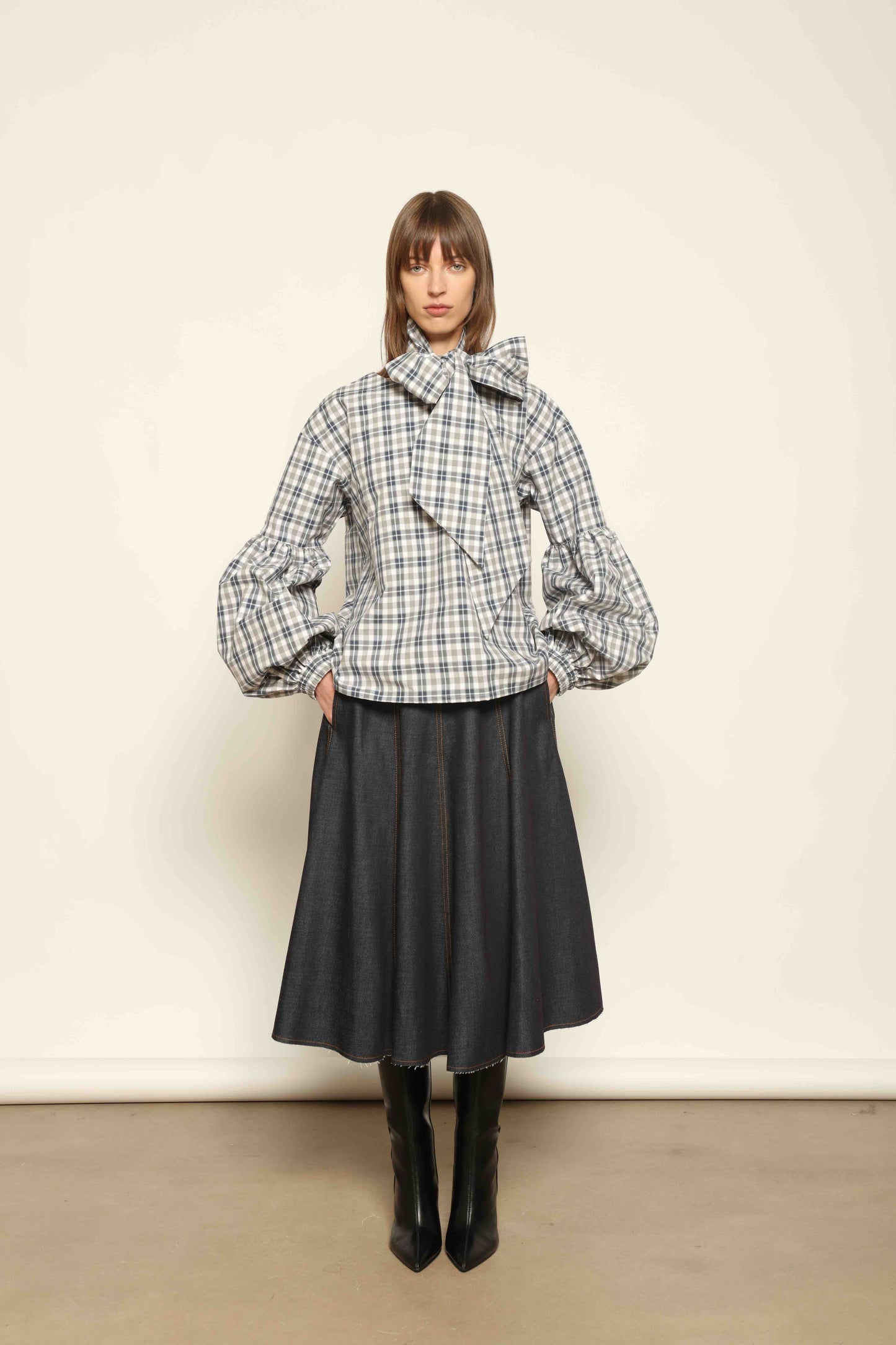 Model wearing Lulu Maxi Check Popeline Cotton Blouse with Scarf by House of Woven Stories, featuring balloon sleeves, grey-white-indigo check, and versatile scarf detail.