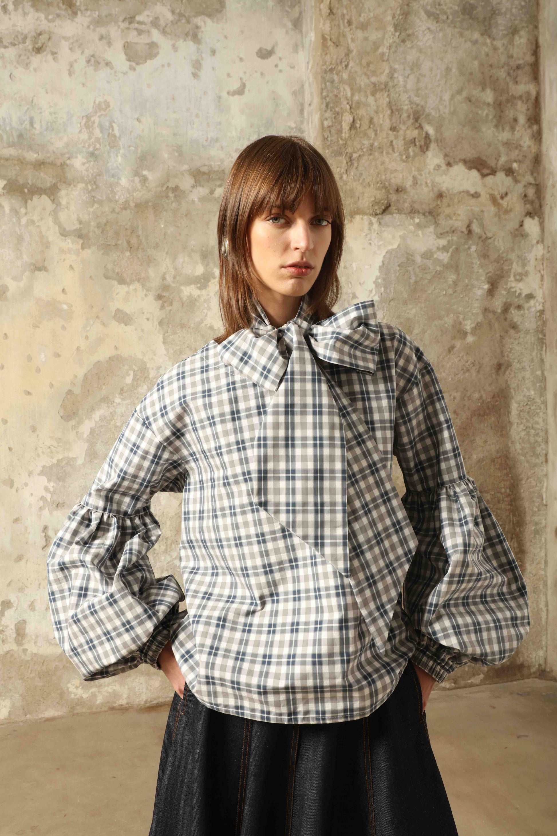 Model wearing Lulu Maxi Check Popeline Cotton Blouse with Scarf by House of Woven Stories, featuring balloon sleeves, grey-white-indigo check, and versatile scarf detail.