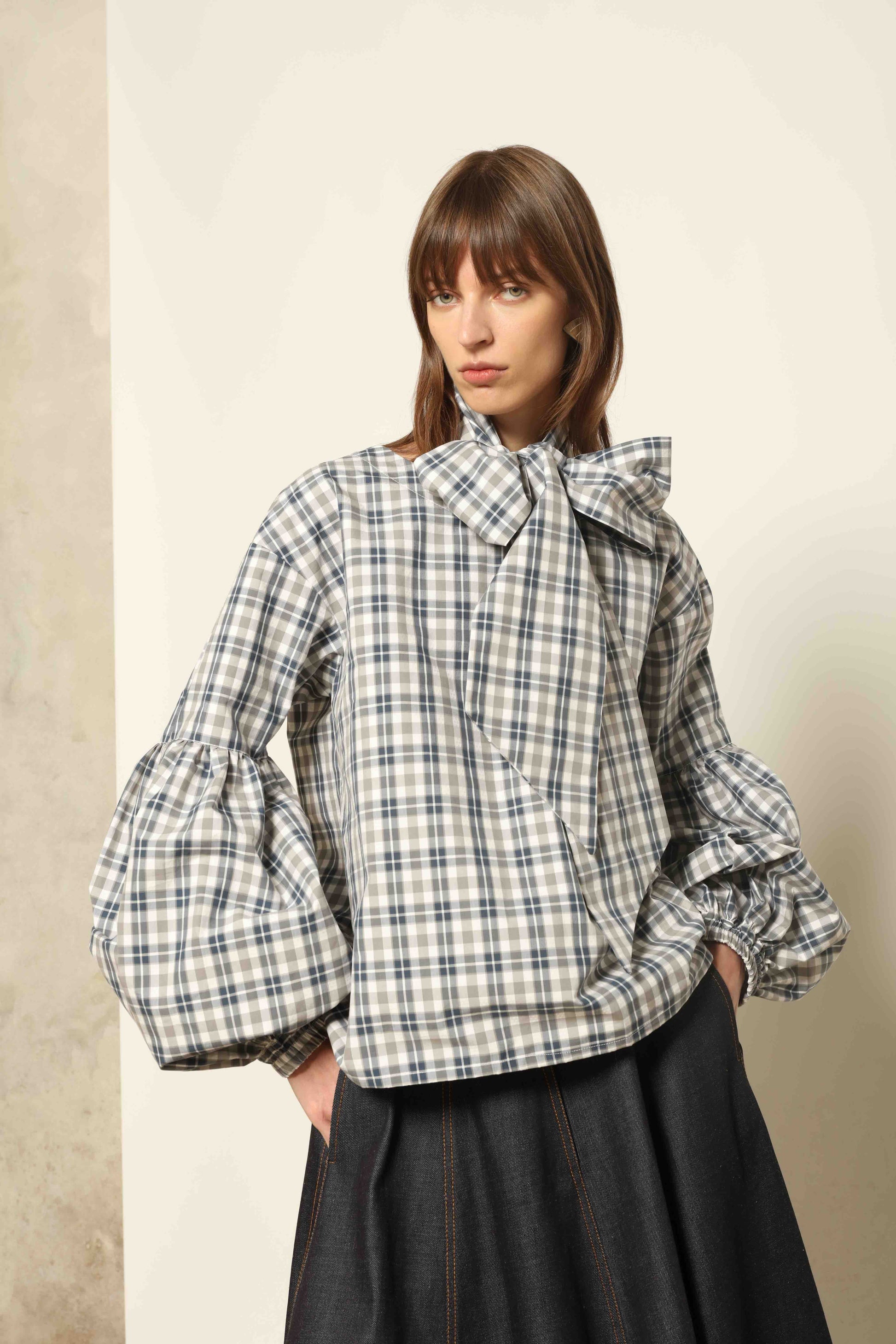 Model wearing Lulu Maxi Check Popeline Cotton Blouse with Scarf by House of Woven Stories, featuring balloon sleeves, grey-white-indigo check, and versatile scarf detail.