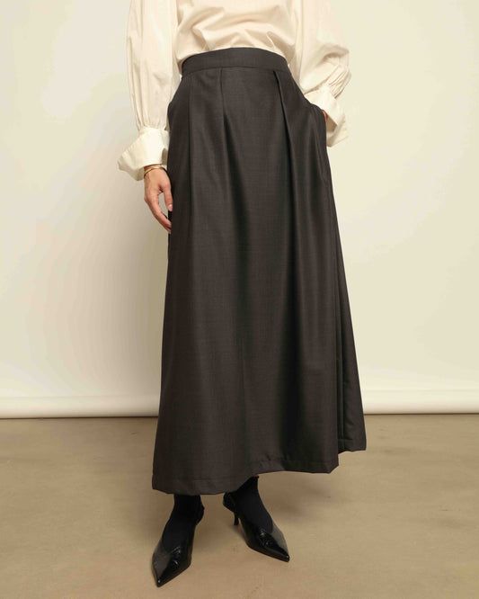 Model is wearing the Moiré Heavy Black Skirt by Lunatica Milano features a rich wave-textured moiré fabric and a high-waisted silhouette. Made in Italy with timeless style and part of House of Woven Stories selection.