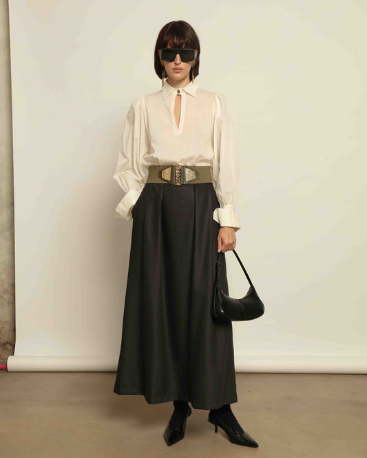 Model is wearing the Moiré Heavy Black Skirt by Lunatica Milano features a rich wave-textured moiré fabric and a high-waisted silhouette. Made in Italy with timeless style and part of House of Woven Stories selection.
