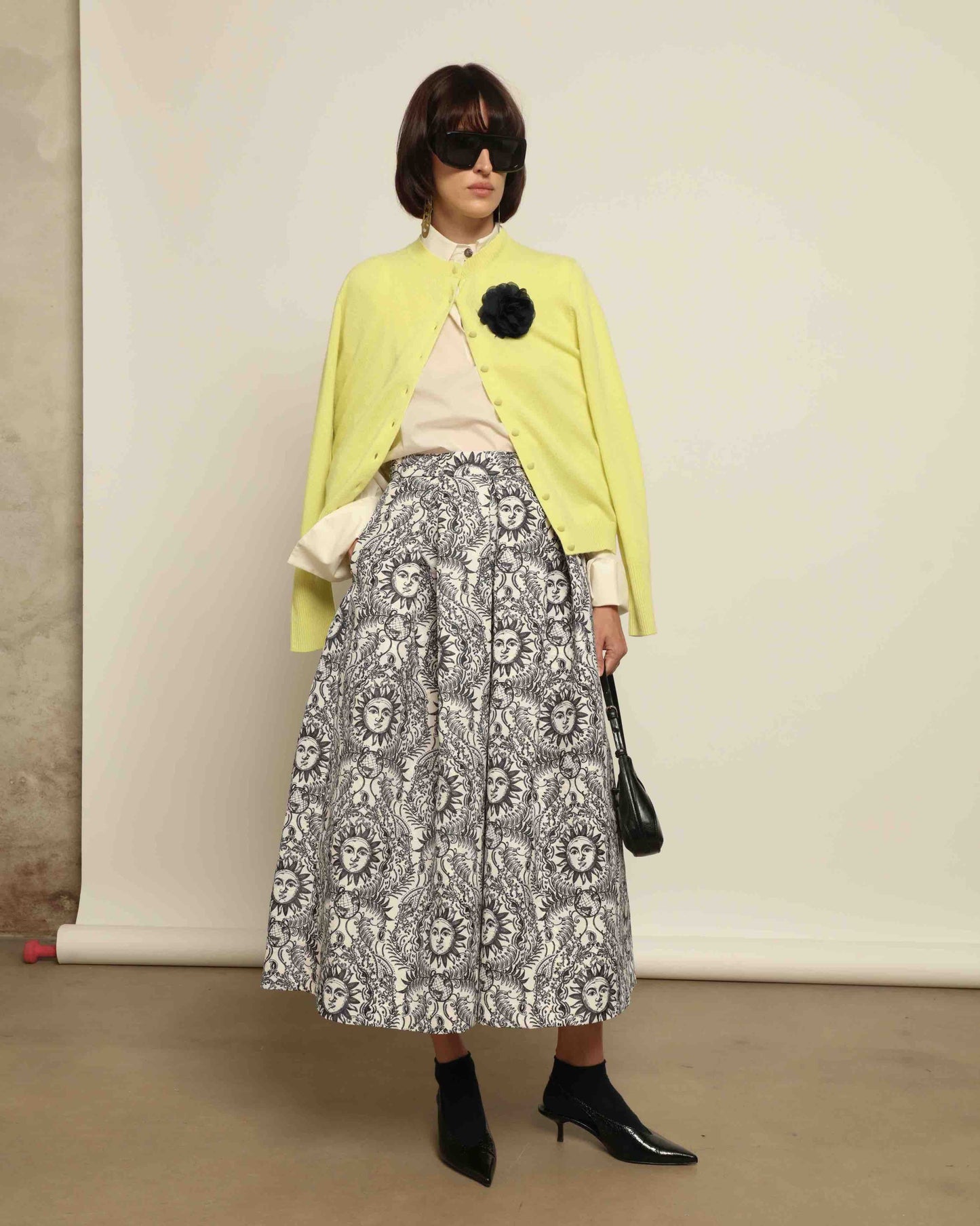 Model is wearing Sun Black and White Skirt by Lunatica Milano. Romantic floral skirt in classic black and white. Elegant, feminine, and handcrafted in Italy. Part of House of Woven Stories selection.