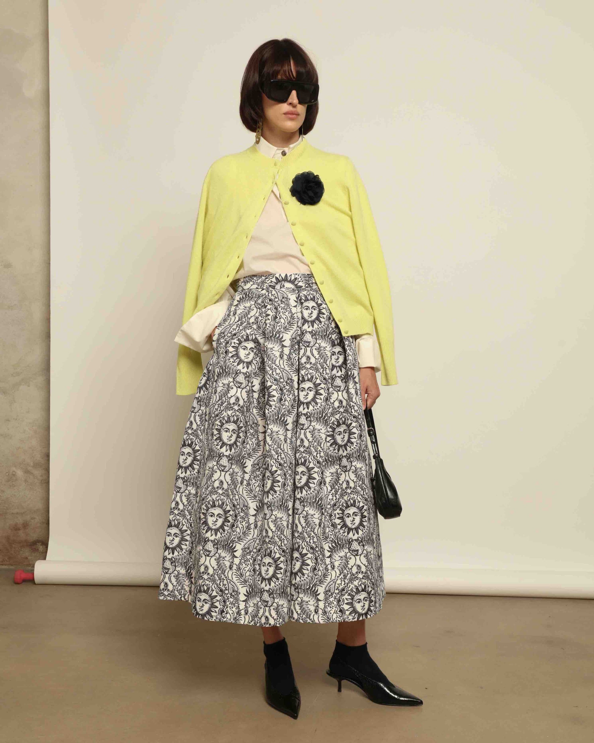 Model is wearing Sun Black and White Skirt by Lunatica Milano. Romantic floral skirt in classic black and white. Elegant, feminine, and handcrafted in Italy. Part of House of Woven Stories selection.