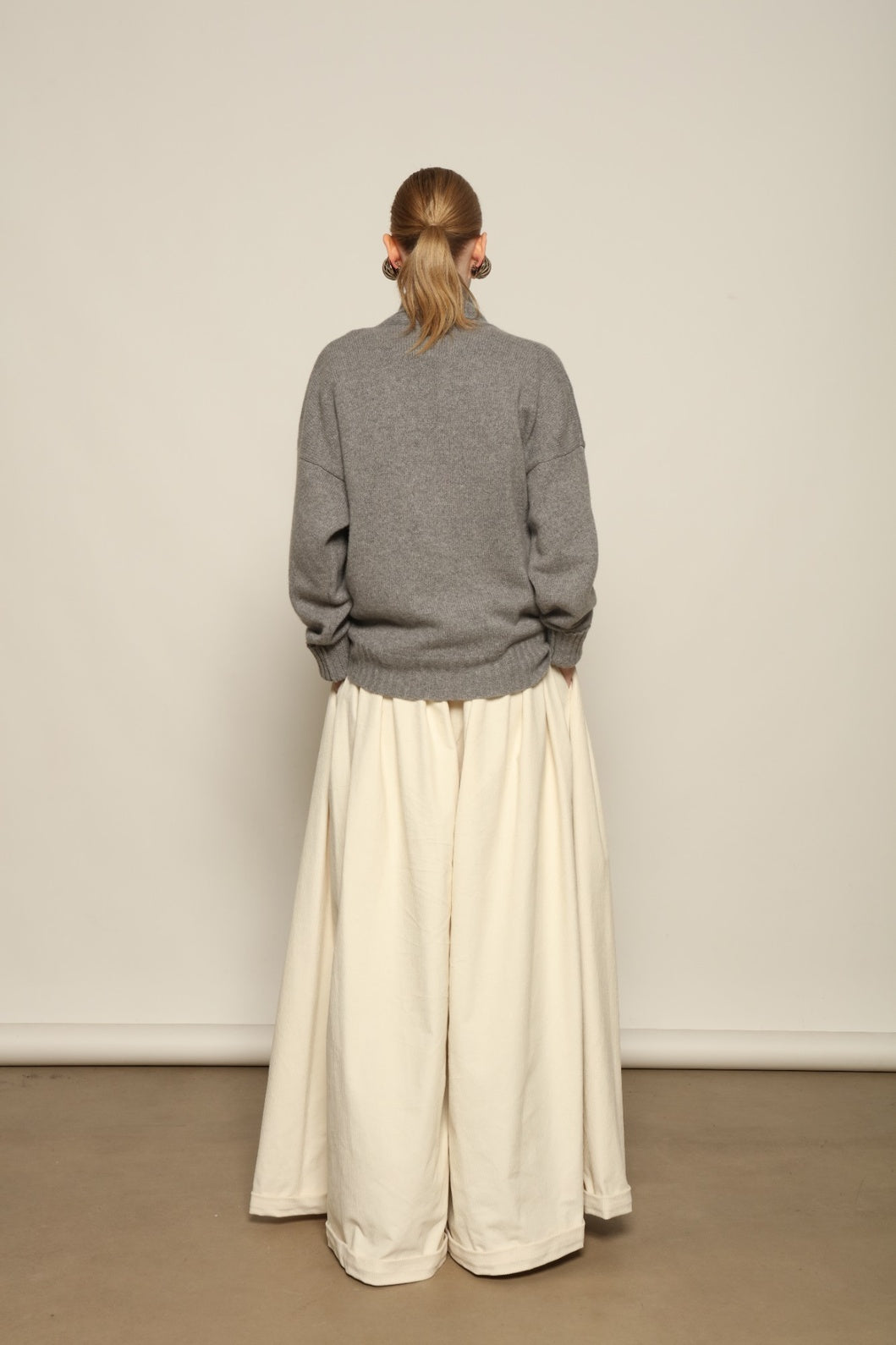 Model is wearing the Birkin Cream Velvet Pant by Maison Jejia, soft cream velvet trousers with a relaxed refined fit and gentle shine, curated in the House of Woven Stories selection