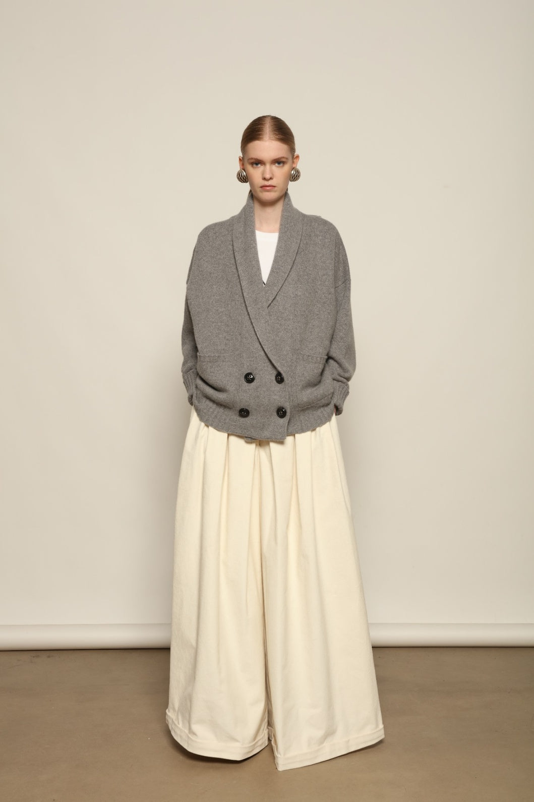 Model is wearing the Birkin Cream Velvet Pant by Maison Jejia, soft cream velvet trousers with a relaxed refined fit and gentle shine, curated in the House of Woven Stories selection