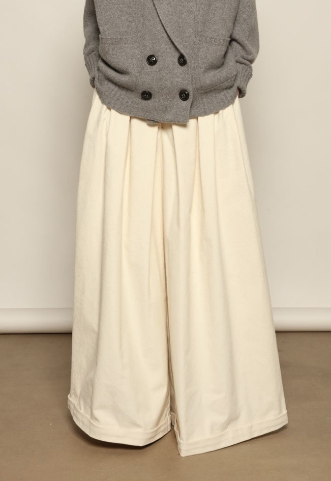 Model is wearing the Birkin Cream Velvet Pant by Maison Jejia, soft cream velvet trousers with a relaxed refined fit and gentle shine, curated in the House of Woven Stories selection