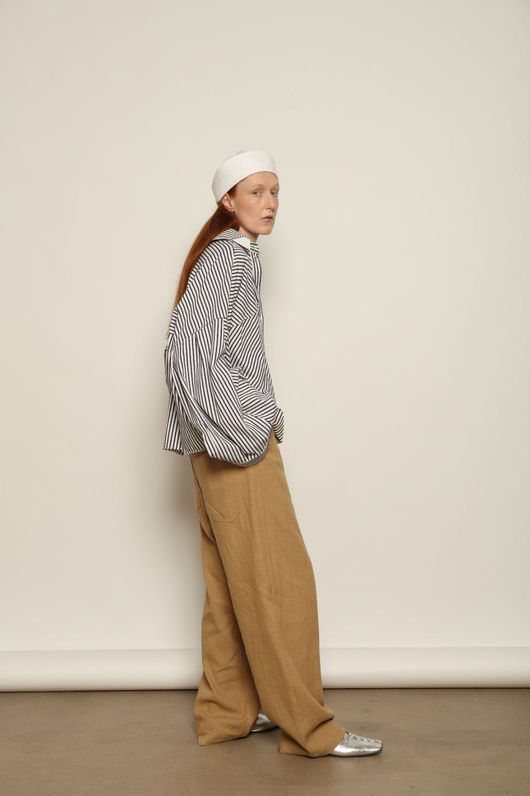 Model is wearing the Maison Jejia Carla Royal Yellow Cotton Pant, handcrafted in Italy with a relaxed silhouette and tailored waistband, from the House of Nomad Stories selection.