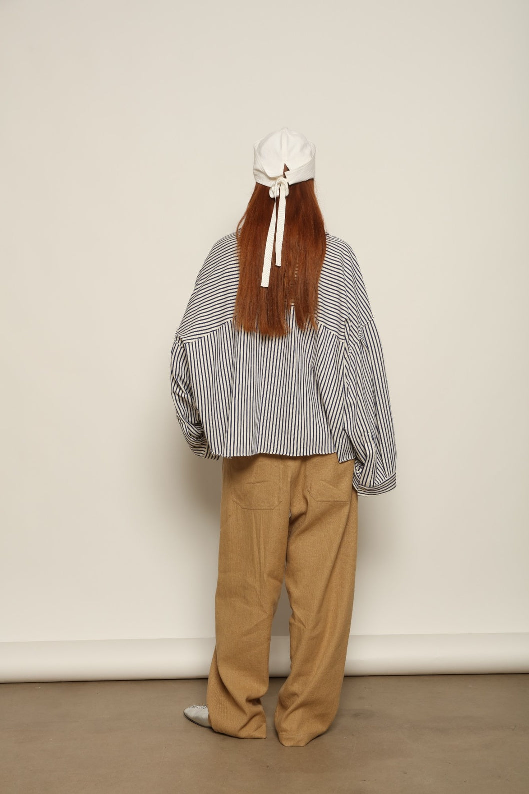 Model is wearing the Maison Jejia Carla Royal Yellow Cotton Pant, handcrafted in Italy with a relaxed silhouette and tailored waistband, from the House of Nomad Stories selection.