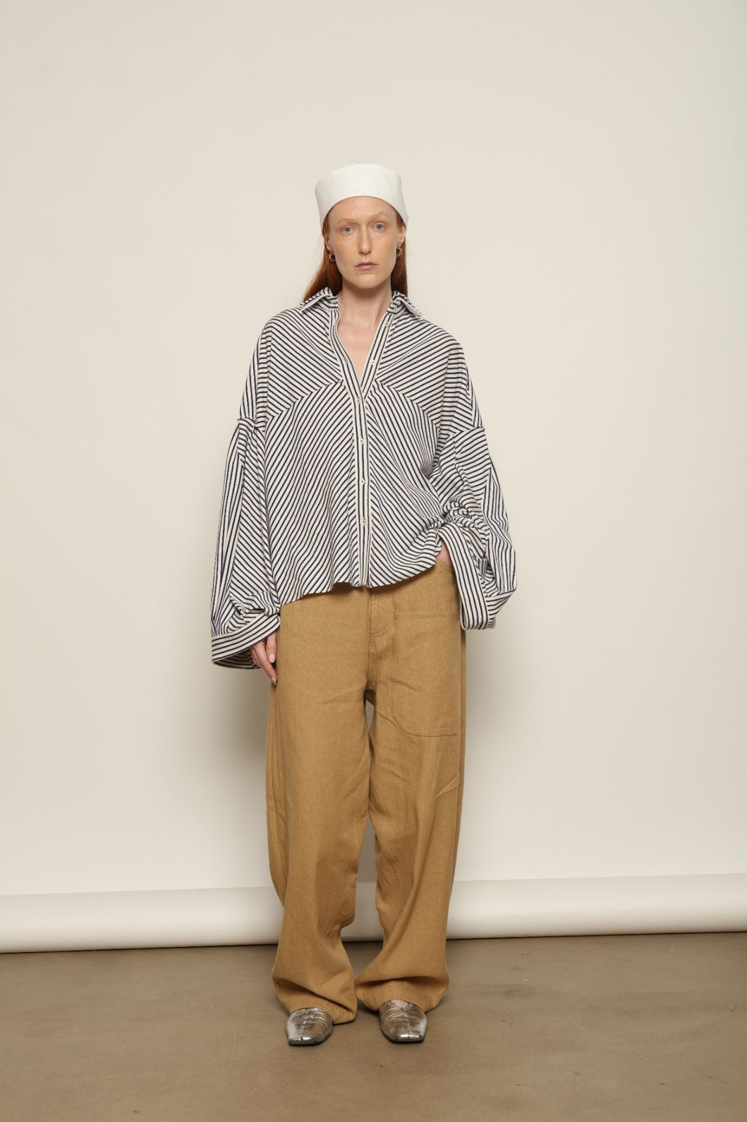 Model is wearing the Maison Jejia Carla Royal Yellow Cotton Pant, handcrafted in Italy with a relaxed silhouette and tailored waistband, from the House of Nomad Stories selection.