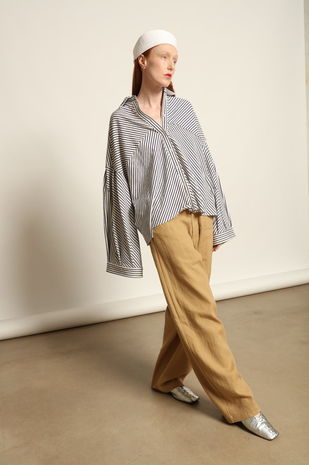 Model is wearing the Maison Jejia Carla Royal Yellow Cotton Pant, handcrafted in Italy with a relaxed silhouette and tailored waistband, from the House of Nomad Stories selection.