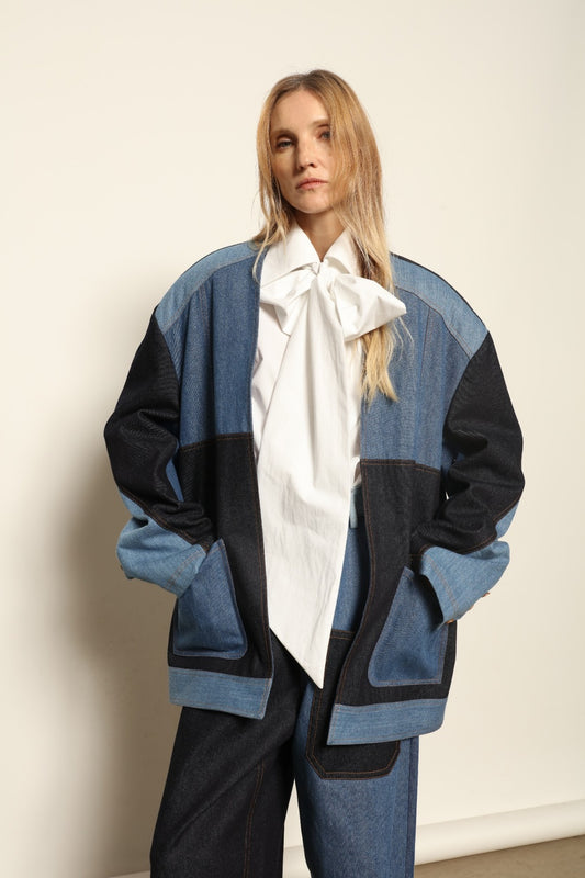 Model is wearing the Jonathan Denim Patchwork Blazer by Maison Jejia, an artisanal tailored blazer made from mixed-wash denim panels with sculpted shoulders and a relaxed sharp silhouette, curated in the House of Woven Stories selection