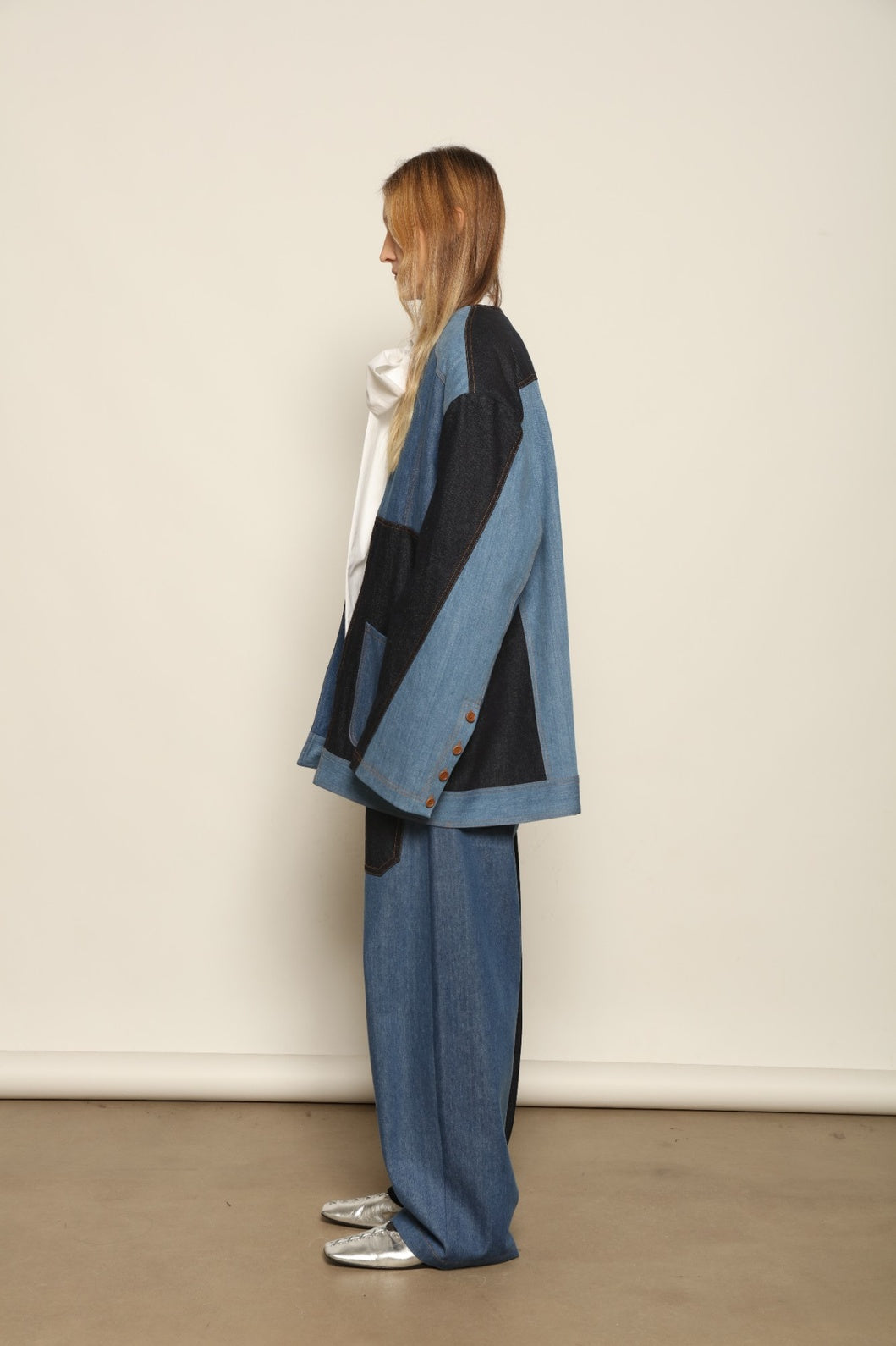 Model is wearing the Jonathan Denim Patchwork Blazer by Maison Jejia, an artisanal tailored blazer made from mixed-wash denim panels with sculpted shoulders and a relaxed sharp silhouette, curated in the House of Woven Stories selection