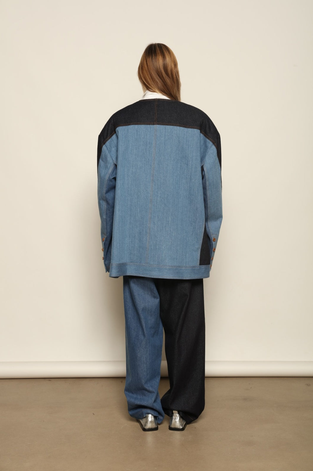 Model is wearing the Jonathan Denim Patchwork Blazer by Maison Jejia, an artisanal tailored blazer made from mixed-wash denim panels with sculpted shoulders and a relaxed sharp silhouette, curated in the House of Woven Stories selection