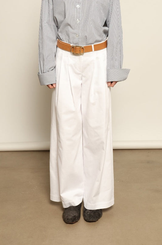 Model is wearing the Katherine White A-Line Pant by Maison Jejia, structured cotton trousers with an elongating A-line silhouette, curated in the House of Woven Stories selection.