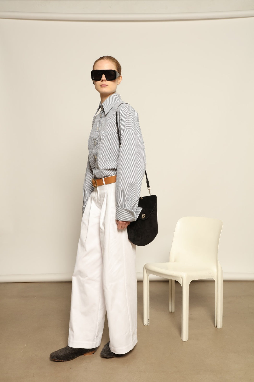 Model is wearing the Katherine White A-Line Pant by Maison Jejia, structured cotton trousers with an elongating A-line silhouette, curated in the House of Woven Stories selection.