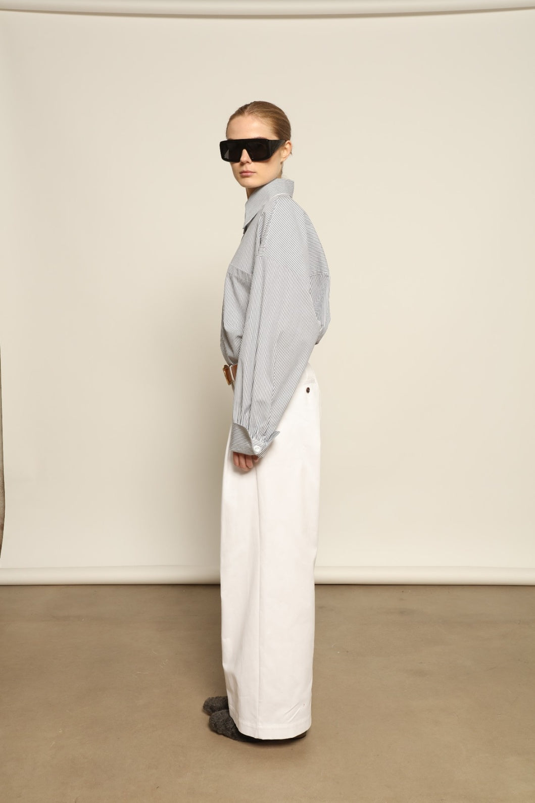 Model is wearing the Katherine White A-Line Pant by Maison Jejia, structured cotton trousers with an elongating A-line silhouette, curated in the House of Woven Stories selection.
