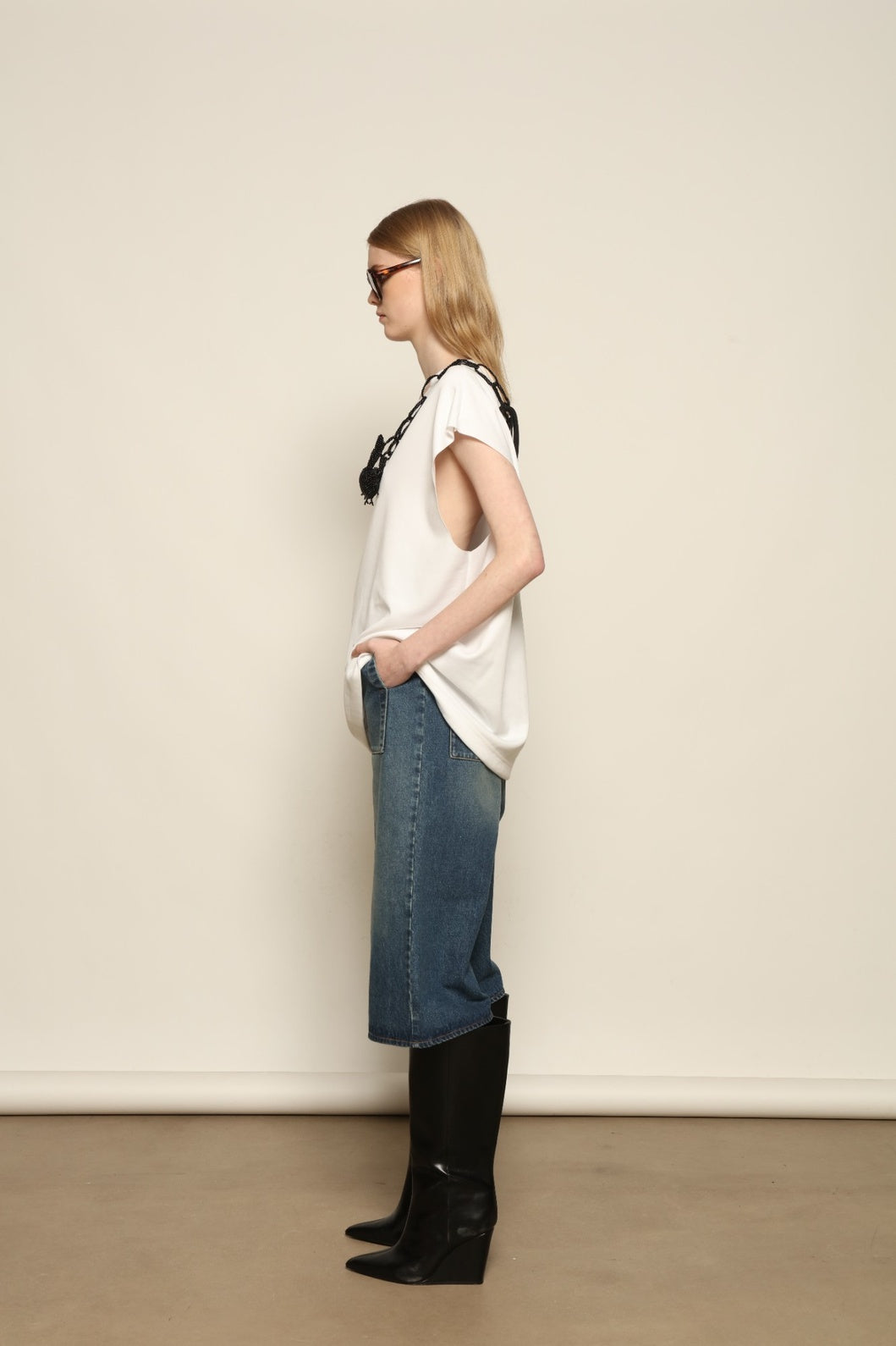 Model is wearing the Tea Cotton Jersey T-Shirt with Black Crab by Maison Jejia, a relaxed cotton tee featuring a playful beaded crab necklace detail, curated in the House of Woven Stories selection.