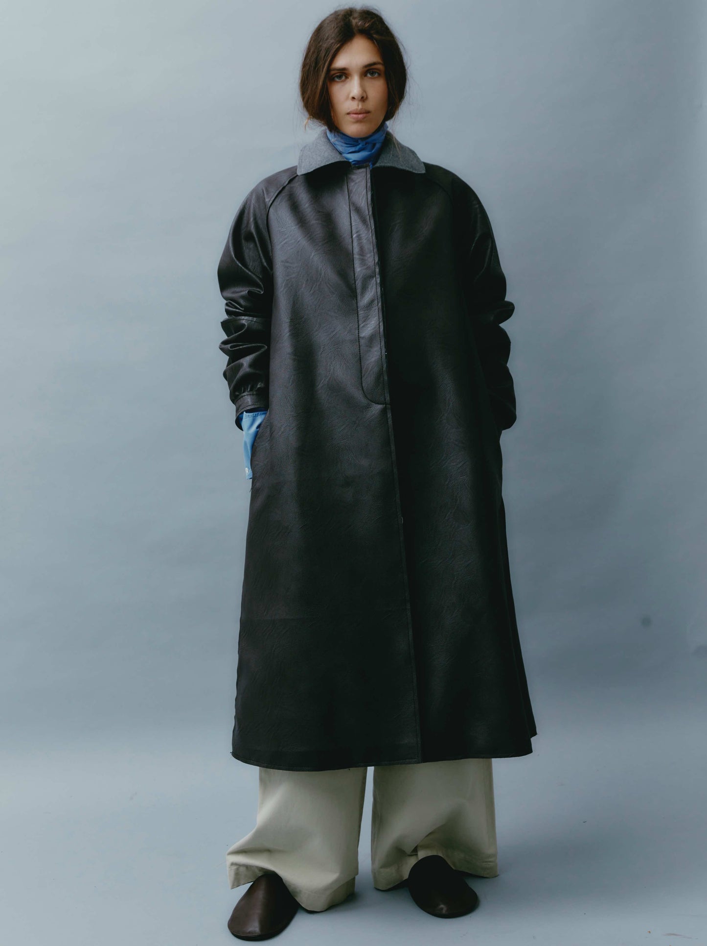 Model is wearing the Maggie Dark Brown Vegan Leather Coat by Maison Jejia, with an oversized fit, grey collar, and concealed closure, perfect for layered, sophisticated looks.