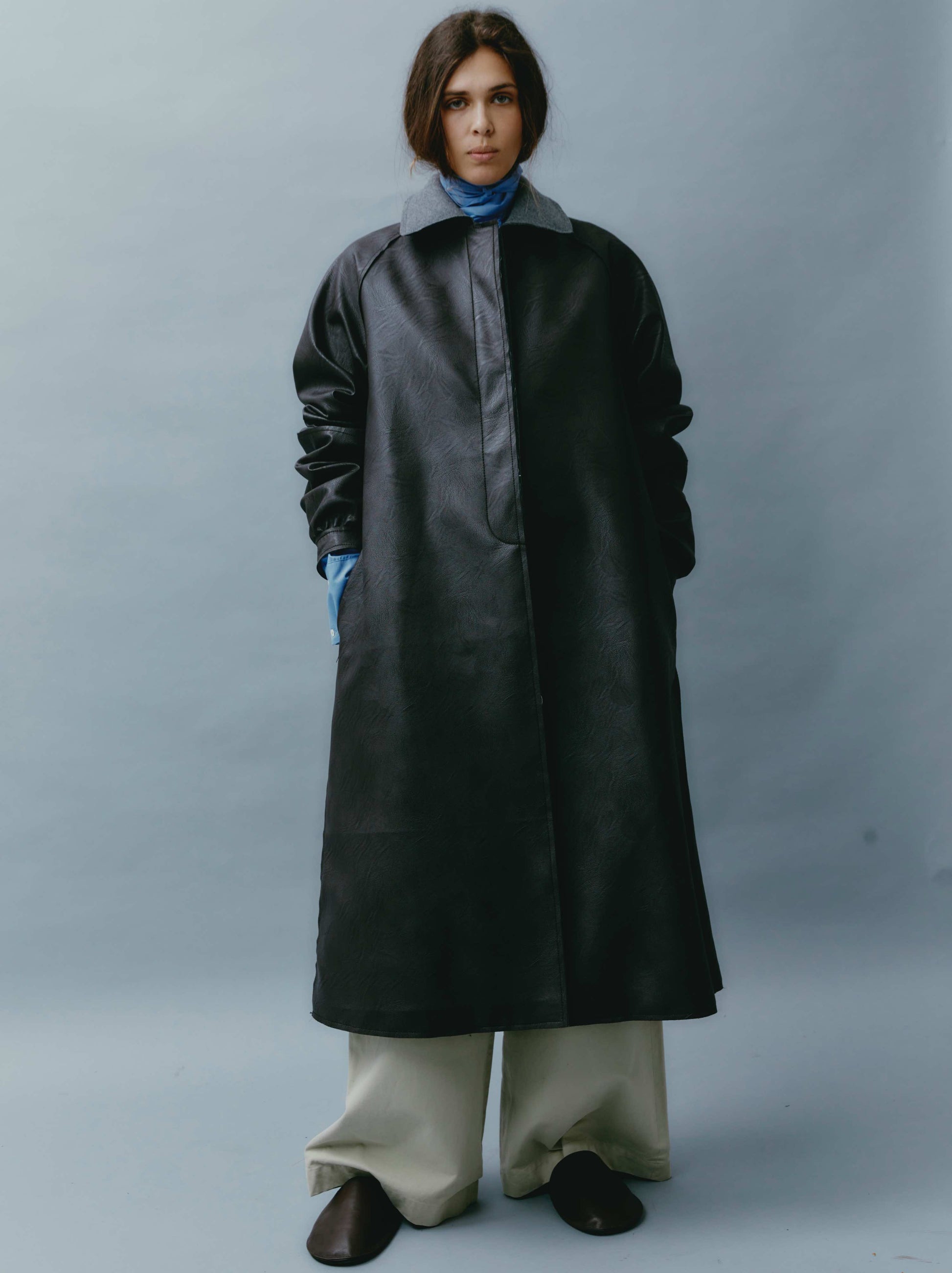 Model is wearing the Maggie Dark Brown Vegan Leather Coat by Maison Jejia, with an oversized fit, grey collar, and concealed closure, perfect for layered, sophisticated looks.
