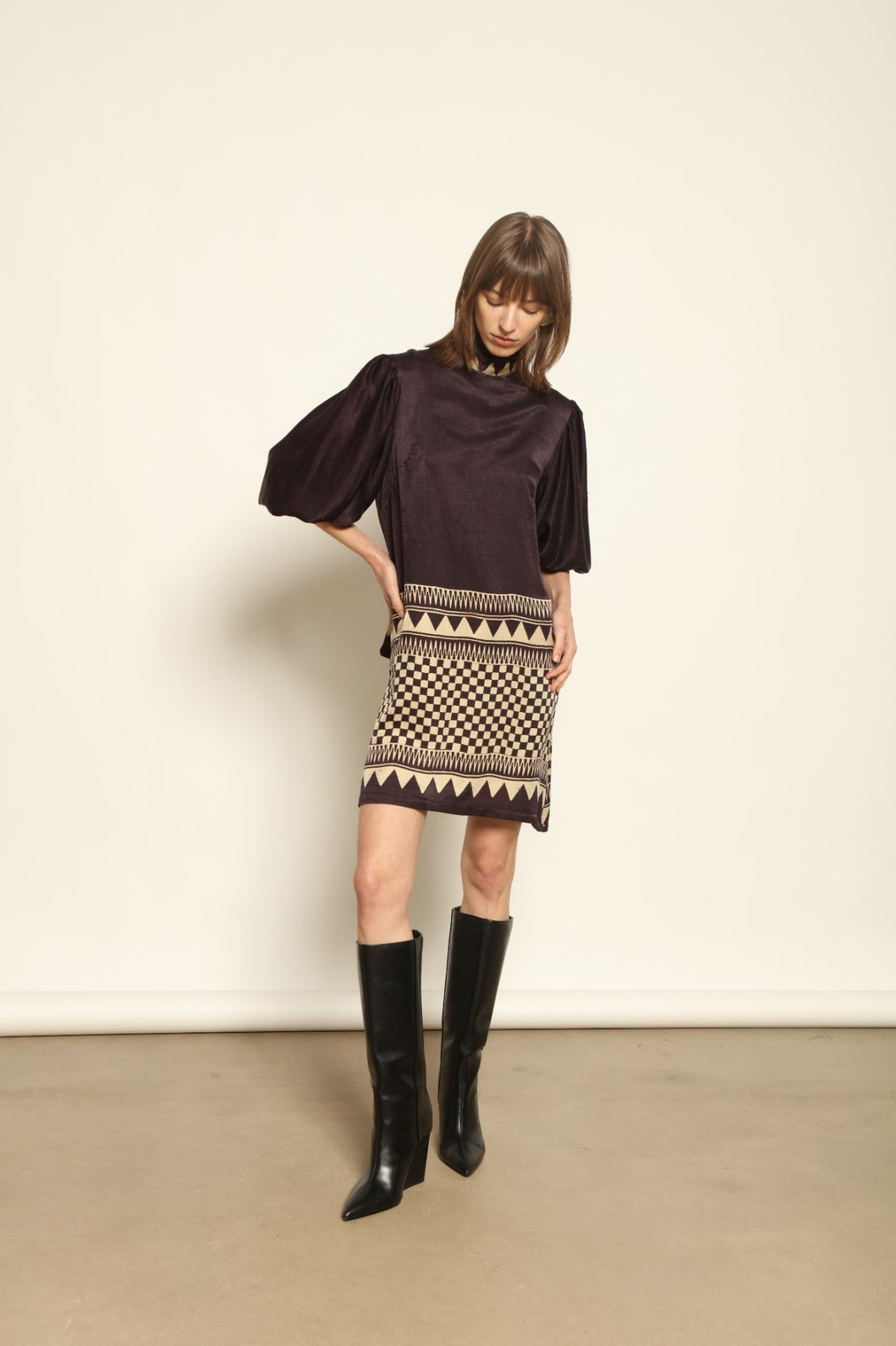 Model is wearing the Malaga Short Silk Dress with Belt by House of Woven Stories, hand-printed in Ajrakh silk with balloon sleeves and a waist belt.