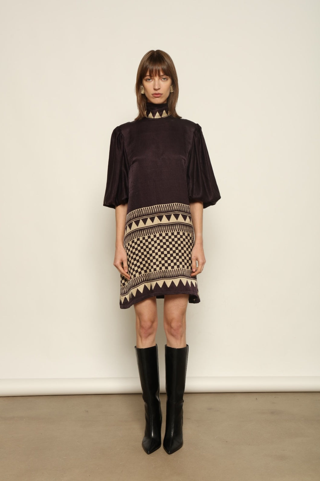 Model is wearing the Malaga Short Silk Dress with Belt by House of Woven Stories, hand-printed in Ajrakh silk with balloon sleeves and a waist belt.