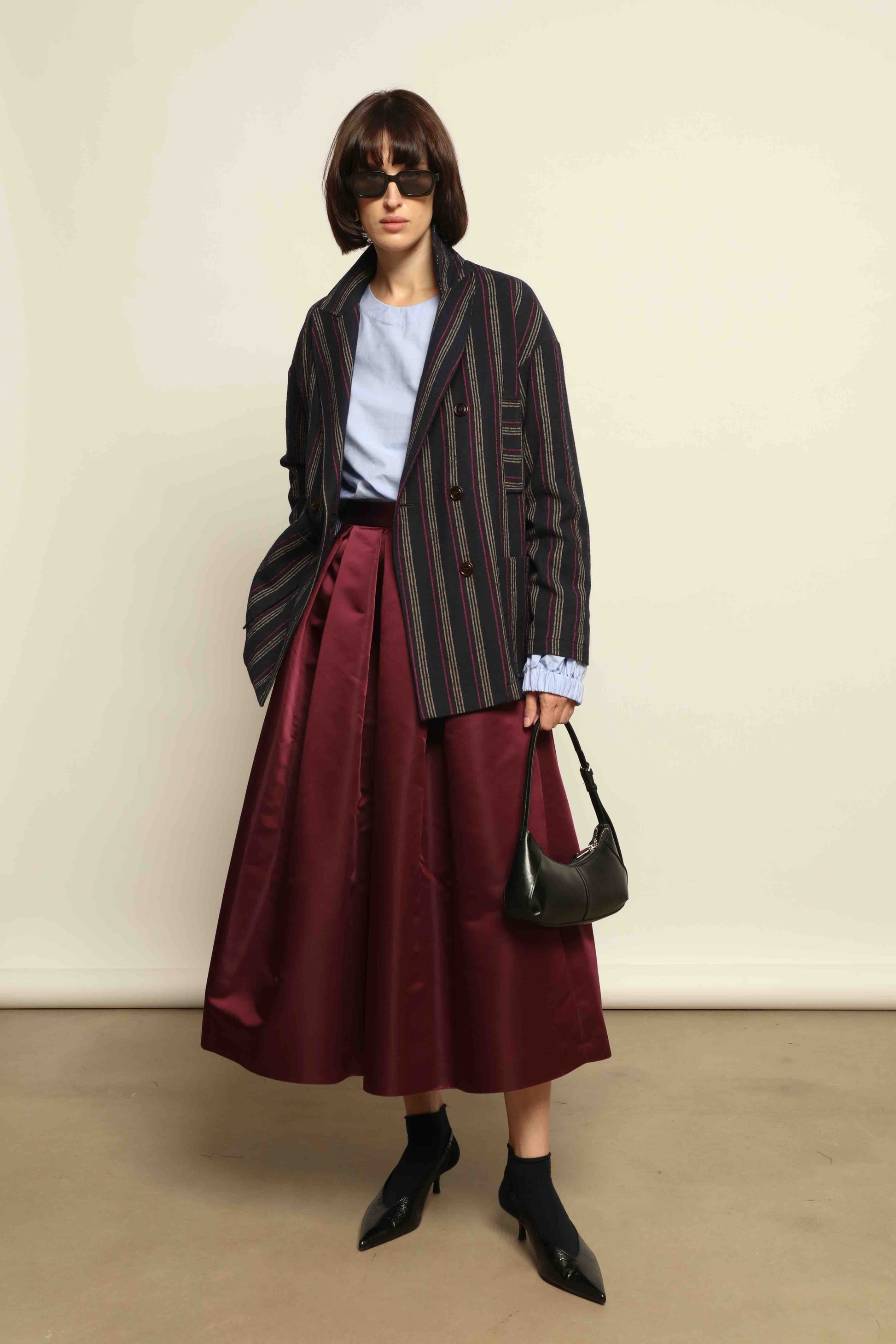 Model is wearing the Navy Blue Striped Double-Breasted Blazer by Balia 8.22, crafted in Italy from virgin wool and cotton with a structured silhouette for timeless elegance.