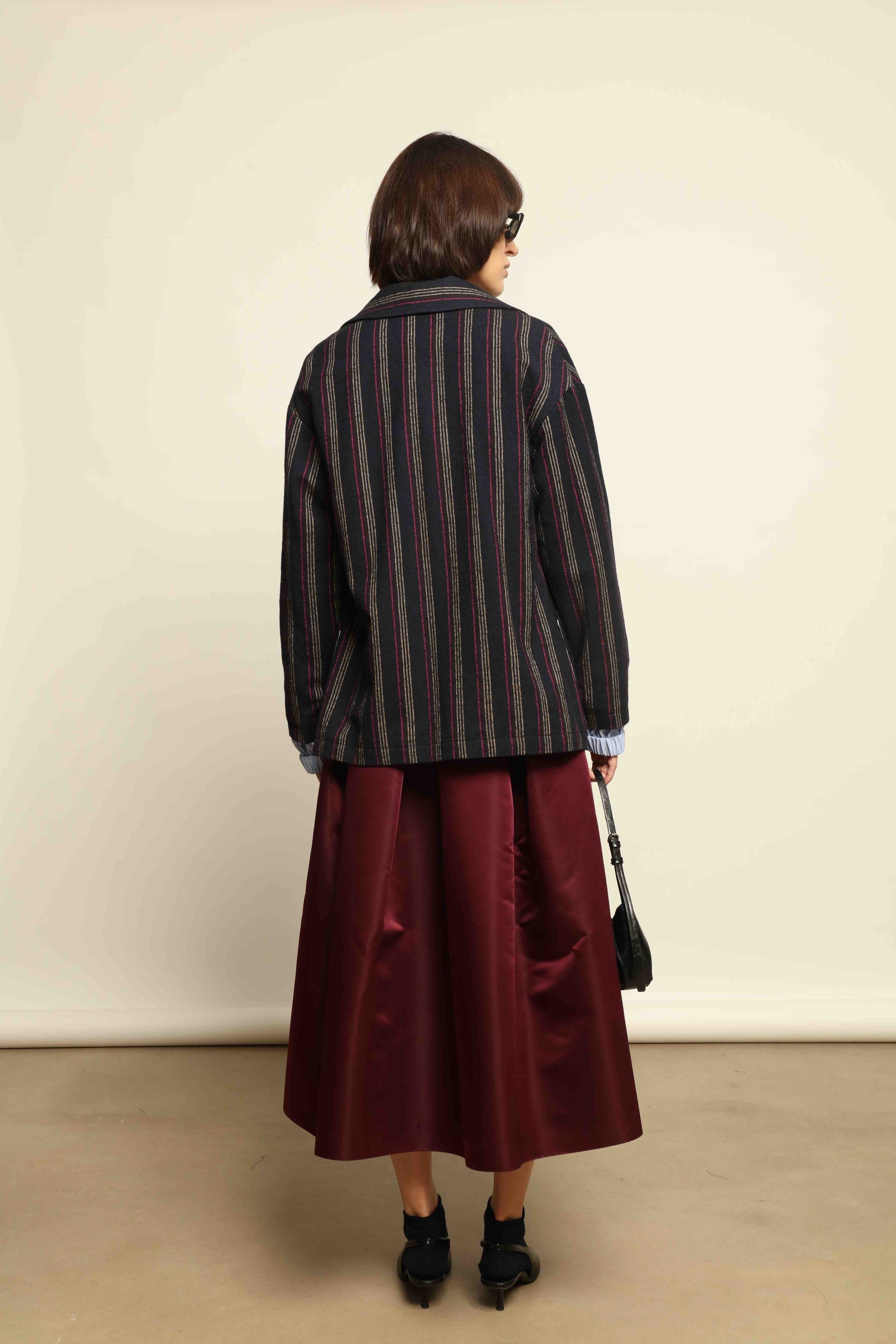 Model is wearing the Navy Blue Striped Double-Breasted Blazer by Balia 8.22, crafted in Italy from virgin wool and cotton with a structured silhouette for timeless elegance.