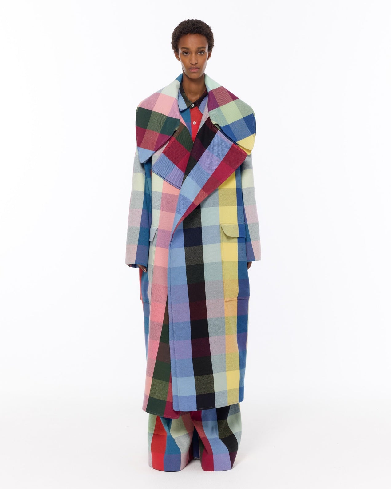 Model is wearing the Double Lapel Overcoat by Marrakshi Life, a hand-woven cotton bouclé coat with oversized plaid, sculptural double lapel and tie belt, curated in the House of Woven Stories selection.