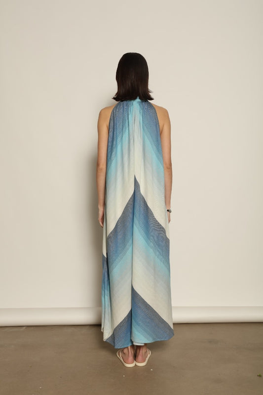 Model is wearing Marrakshi Life halter maxi dress in blue striped cotton, lightweight breathable sleeveless halter neck dress with flowy silhouette from the curated selection of House of Woven Stories