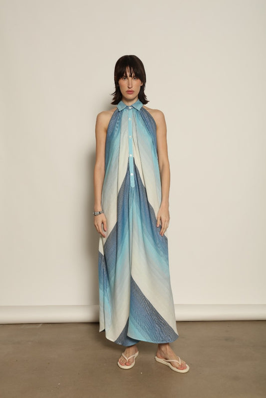 Model is wearing Marrakshi Life halter maxi dress in blue striped cotton, lightweight breathable sleeveless halter neck dress with flowy silhouette from the curated selection of House of Woven Stories