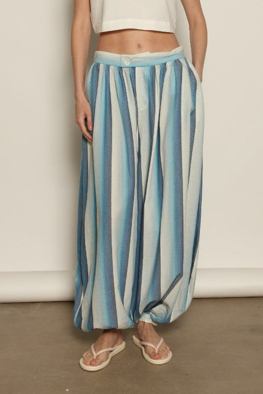 Model is wearing Marrakshi Life harem pants in striped handwoven cotton, voluminous relaxed fit lightweight breathable trousers from the curated selection of House of Woven Stories