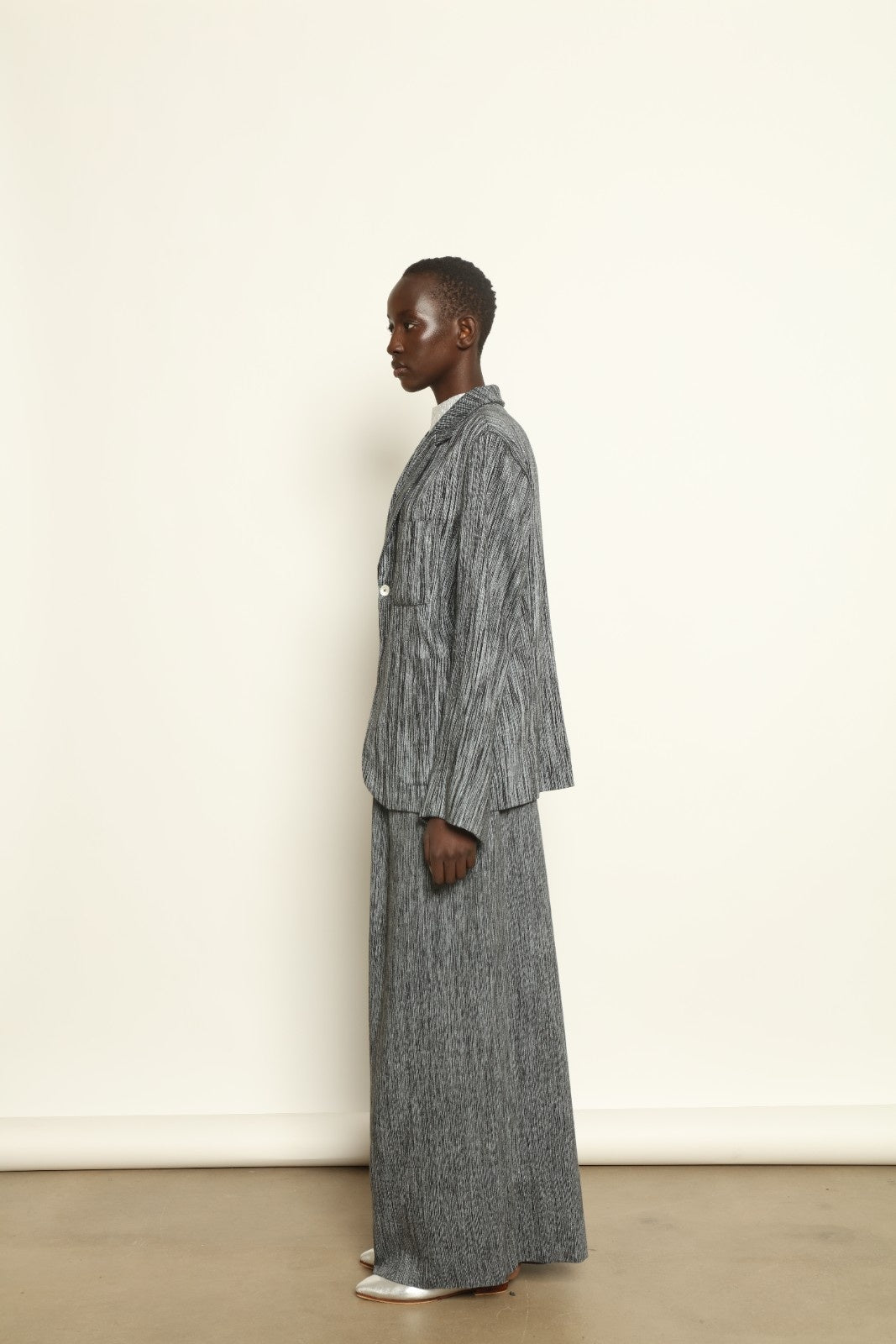 Model is wearing the Mid Rise Grey Chambray Pant by Marrakshi Life, part of House of Woven Stories collection, handwoven cotton wide-leg pants with relaxed fit and subtle textured chambray