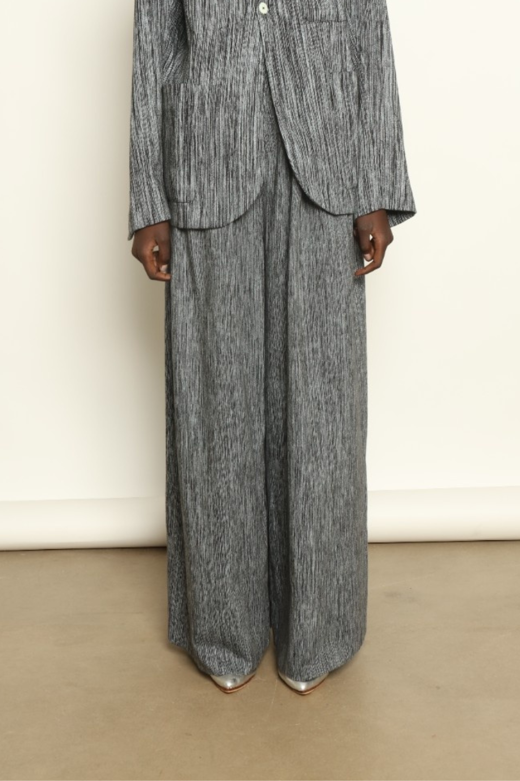 Model is wearing the Mid Rise Grey Chambray Pant by Marrakshi Life, part of House of Woven Stories collection, handwoven cotton wide-leg pants with relaxed fit and subtle textured chambray