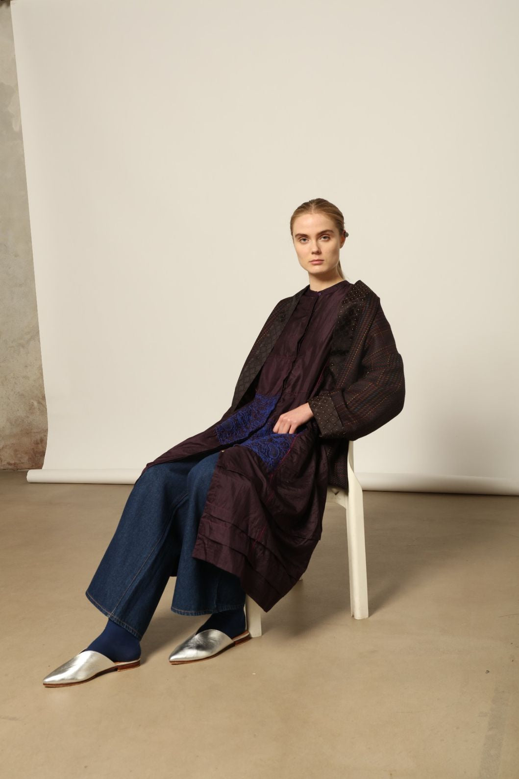 Model is wearing the Miraj 121 Pure Silk Dress by Injiri, handcrafted in maroon silk with detailed navy hand embroidery, showcasing Indian craftsmanship and refined elegance.
