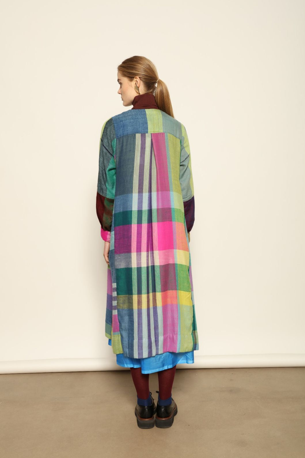 Model is wearing the Miraj 55 Pure Cashmere Dress by Injiri, crafted from the finest cashmere with bold multicolor check patterns, blending warmth, artistry, and refined elegance.