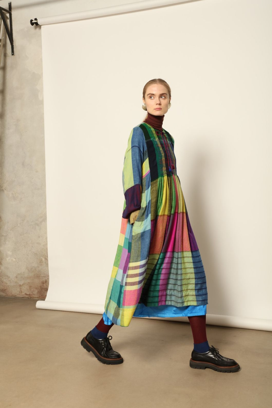 Model is wearing the Miraj 55 Pure Cashmere Dress by Injiri, crafted from the finest cashmere with bold multicolor check patterns, blending warmth, artistry, and refined elegance.