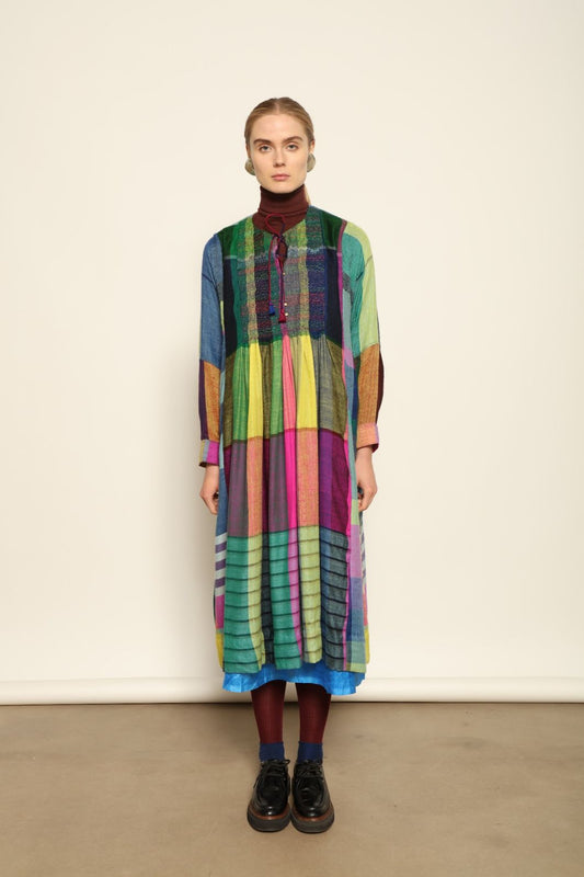 Model is wearing the Miraj 55 Pure Cashmere Dress by Injiri, crafted from the finest cashmere with bold multicolor check patterns, blending warmth, artistry, and refined elegance.