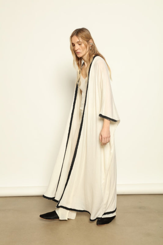 Model Nastia wearing the Natural White Long Cardigan by Mirror in the Sky, a handmade 100% cashmere long cardigan with flowing silhouette and natural undyed finish.