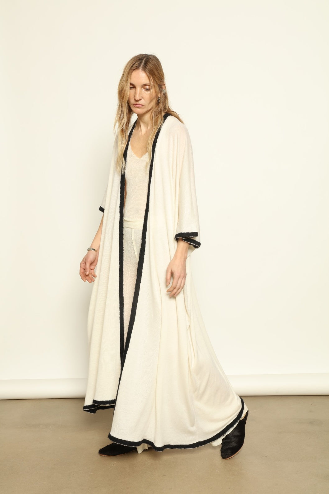 Model Nastia wearing the Natural White Long Cardigan by Mirror in the Sky, a handmade 100% cashmere long cardigan with flowing silhouette and natural undyed finish.
