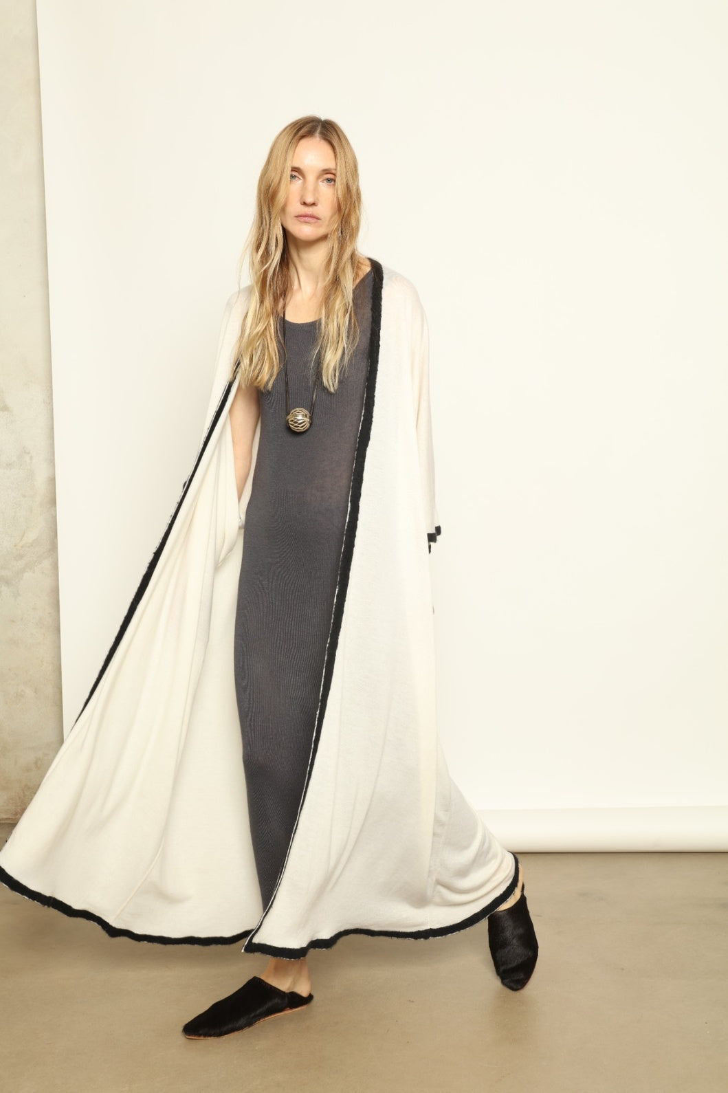 Model Nastia wearing the Natural White Long Cardigan by Mirror in the Sky, a handmade 100% cashmere long cardigan with flowing silhouette and natural undyed finish.
