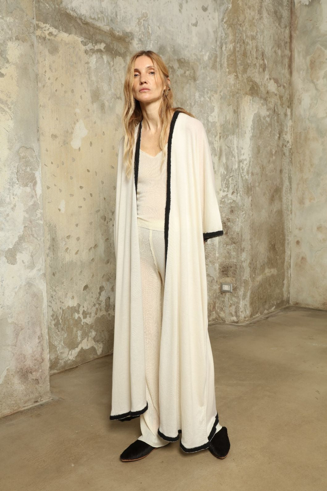 Model Nastia wearing the Natural White Long Cardigan by Mirror in the Sky, a handmade 100% cashmere long cardigan with flowing silhouette and natural undyed finish.