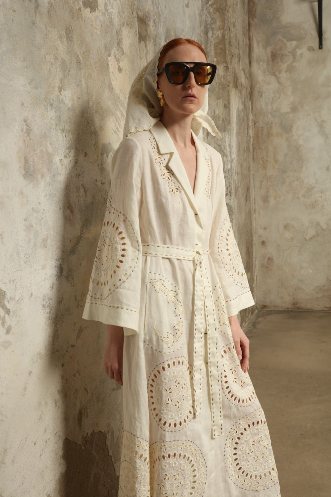 Model is wearing the My Sleeping Gypsy Sarah Long Dress in Ivory, handcrafted from linen with delicate lace, embroidery, and 24-carat bead accents, from the House of Nomad Stories selection.