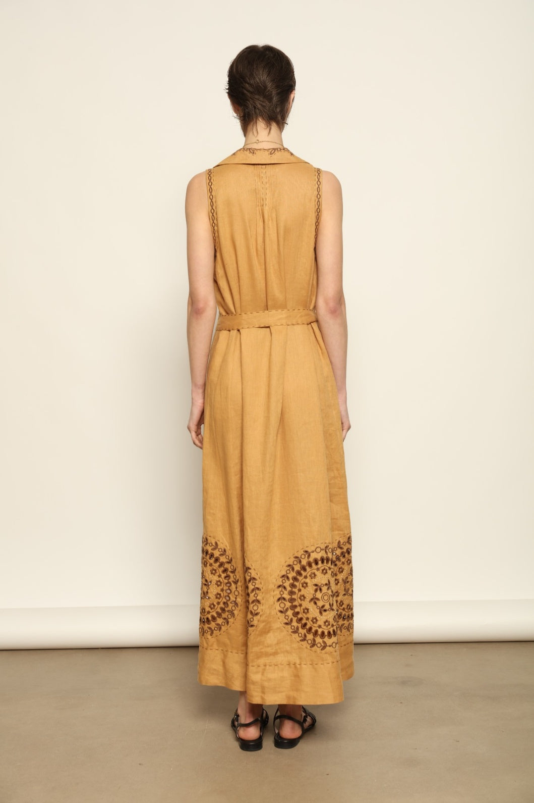 Model is wearing the My Sleeping Gypsy Sarah Long Sleeveless Dress "Merezhivo," handcrafted with Richelieu technique and 24-carat gilded bead detailing, from the House of Nomad Stories selection.