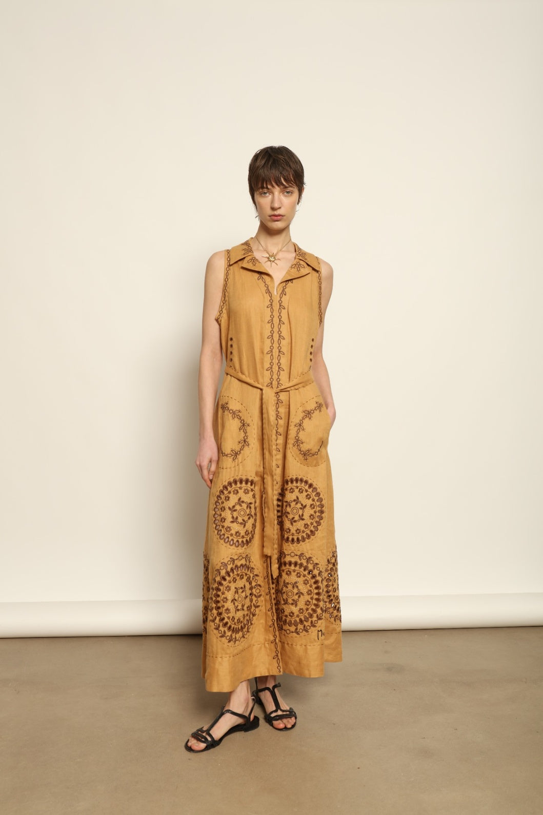 Model is wearing the My Sleeping Gypsy Sarah Long Sleeveless Dress "Merezhivo," handcrafted with Richelieu technique and 24-carat gilded bead detailing, from the House of Nomad Stories selection.