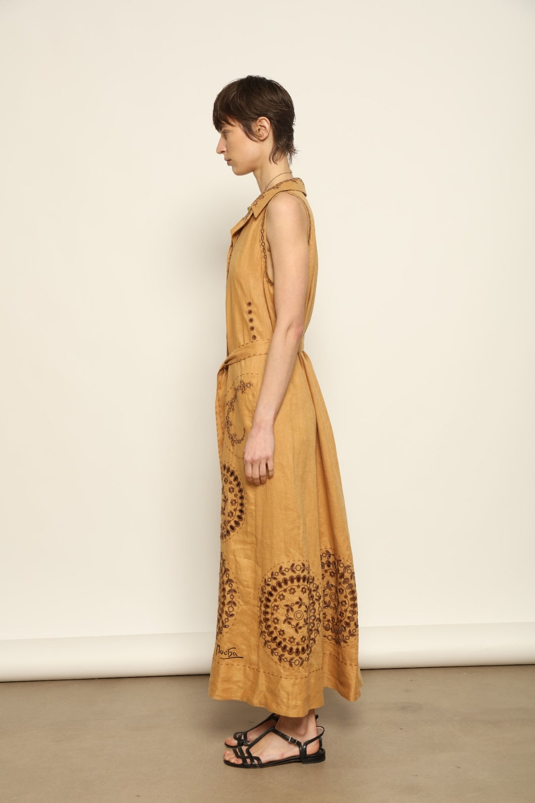 Model is wearing the My Sleeping Gypsy Sarah Long Sleeveless Dress "Merezhivo," handcrafted with Richelieu technique and 24-carat gilded bead detailing, from the House of Nomad Stories selection.