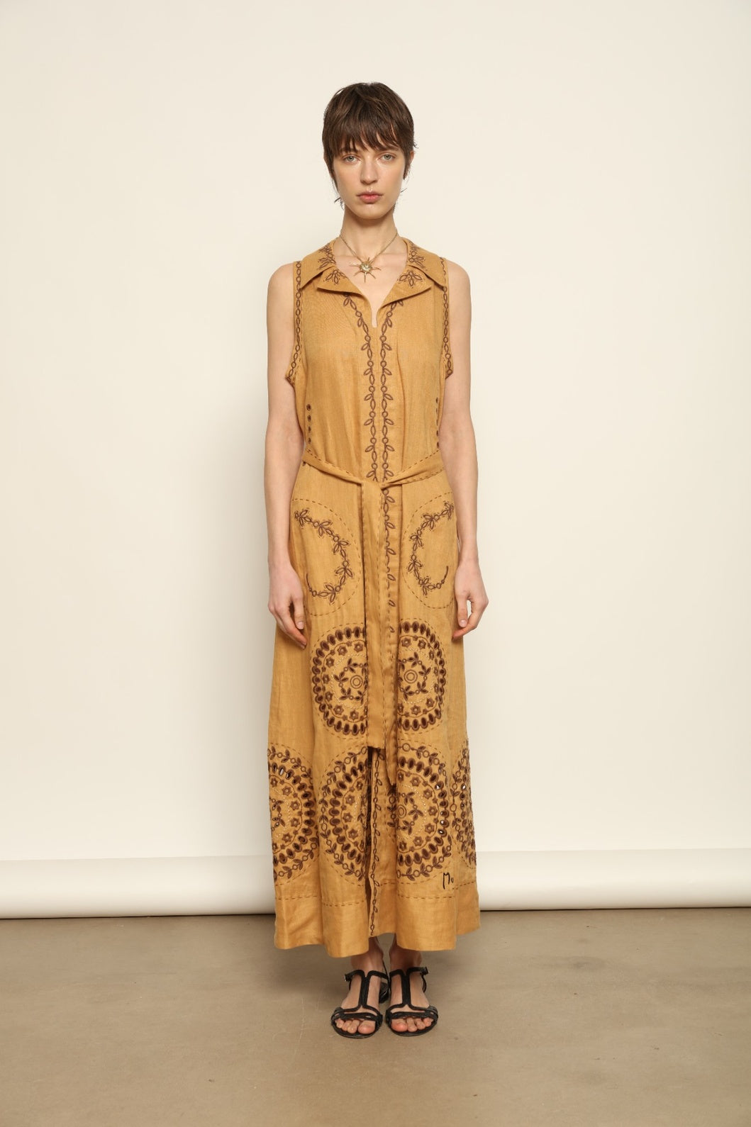 Model is wearing the My Sleeping Gypsy Sarah Long Sleeveless Dress "Merezhivo," handcrafted with Richelieu technique and 24-carat gilded bead detailing, from the House of Nomad Stories selection.