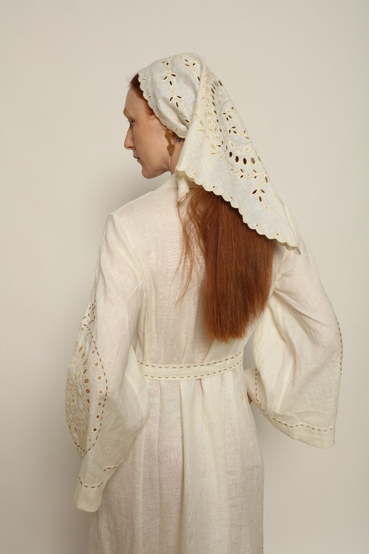 Model is wearing the My Sleeping Gypsy Slavia Head Scarf, handcrafted from linen with intricate embroidery inspired by Slavic heritage, from the House of Nomad Stories selection.