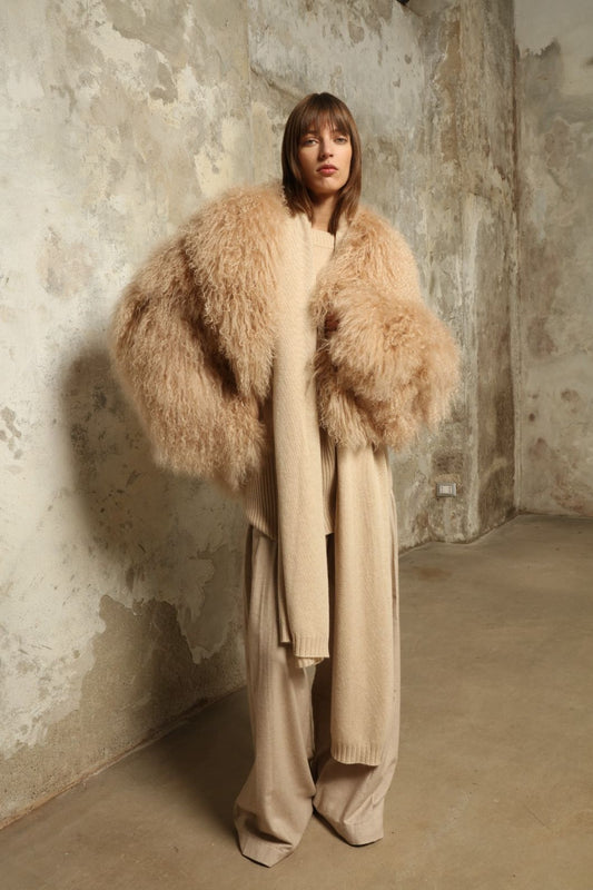 Model wearing the Natural Leni Cashmere Scarf by House of Woven Stories, made from 100% pure Inner Mongolia cashmere, featuring a soft natural shade, lightweight drape, smooth texture, lasting warmth, and ethical sustainable craftsmanship