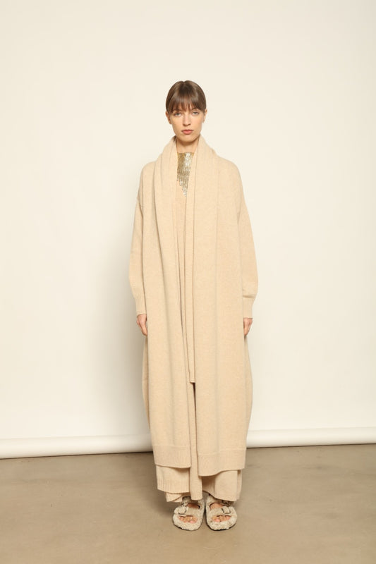 Model wearing the Natural Paula Cashmere Coat by House of Woven Stories, made from 100% pure Inner Mongolia cashmere, featuring a soft natural shade, open-front design, elegant drape, cozy warmth, and sustainable, ethically crafted luxury