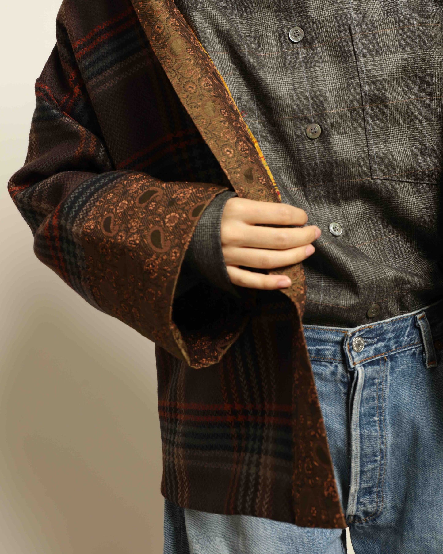 Model is wearing the Obidi Checked Kantha Jacket in wool and silk, with a silk collar and unique printed silk lining, a one-of-a-kind artisanal piece. Part of House of Woven Stories selection.